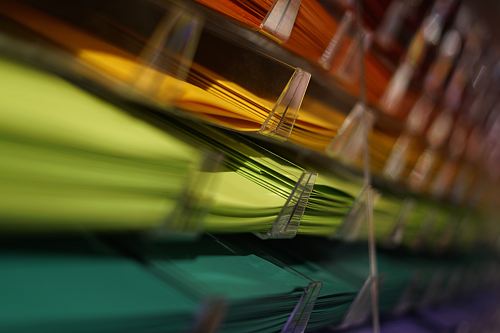 selective focus photography of yellow and green papers